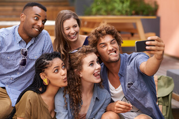 All aboard the Selfie express. A group shot of university students having fun at campus.