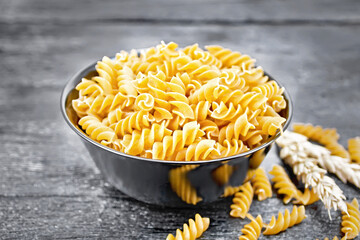 Fusilli whole grain in bowl on board