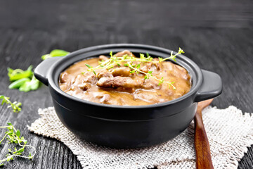 Goulash of beef in pan on black board