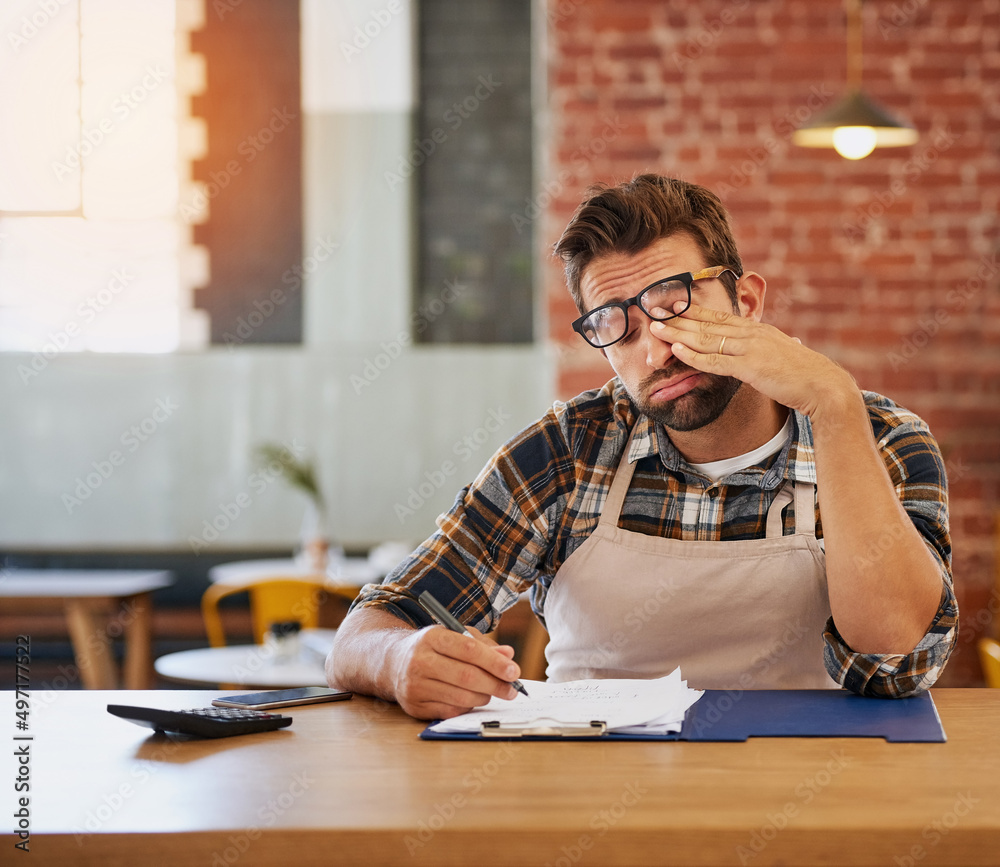 Poster this admin will be the end of me. shot of an exhausted young business owner doing admin at a table i