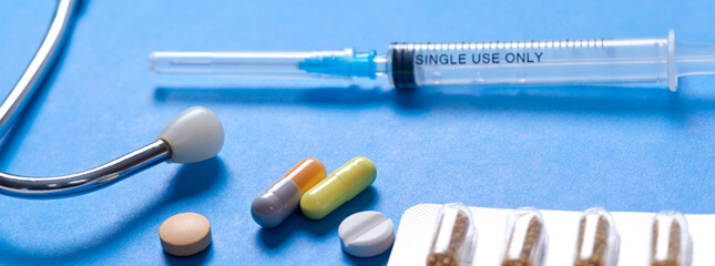 Medical syringe with a needle and pills. Corona virus vaccine.