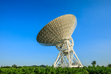 Astronomical radio telescope under blue sky