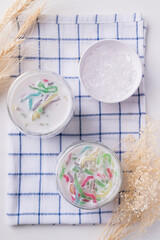 Thai dessert (Lod Chong), Colorful rice flour jelly with coconut milk in glass and ice, Top view