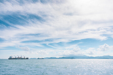 Cargo ship on horizon, clear sky