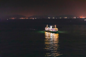 Ferry passing victoria harbour at night, Hong Kong