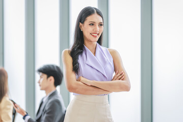 Fototapeta premium Millennial Asian young happy beautiful female businesswoman employee staff in formal business suit standing smiling hands posing in company office meeting room.