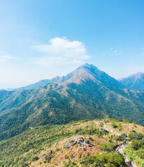 Fototapeta premium Many people hiking on the path to the famos location, Sunset Peak, Lantau Island, Hong Kong