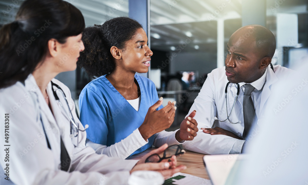 Poster strategizing skills that saves lives. shot of a group of doctors having a meeting in a hospital.