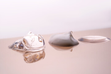Cream, hyaluronic gel and serum on a beige background.