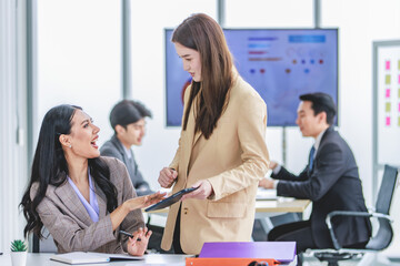 Asian young female professional successful businesswoman mentor teaching training helping supporting new recruitment employee staff learning job task online via computer in company office workstation