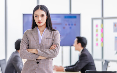 Millennial Asian young happy beautiful female businesswoman employee staff in formal business suit standing smiling hands posing in company office meeting room.
