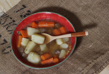 Hearty Beef Stew With Potato and and Carrots on Vintage Burlap potato Bag