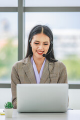 Asian young beautiful happy female businesswoman customer service call center operater in formal...