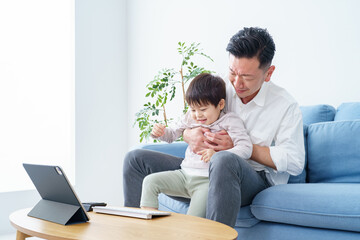 Fototapeta premium A child who disturbs his father who teleworks