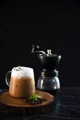 Iced coffee cup with ice and coffee beans on old wooden floor