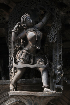 Stone Sculpture of Beautiful Female (Madanikas) with selective focus, 12th century Hindu temple, Ancient stone art and sculptures in each pillars, Chennakeshava Temple, Belur, Karnataka, India.