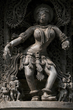 Stone Sculpture of Beautiful Female (Madanikas) with selective focus, 12th century Hindu temple, Ancient stone art and sculptures in each pillars, Chennakeshava Temple, Belur, Karnataka, India.