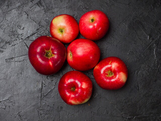 Red apples. Several fruits on a black background. Studio photography. View from above