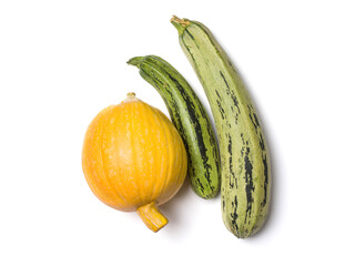 Yellow pumpkin and green zucchini. Several vegetables on a white background. Studio photography. View from above
