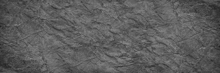 Black white rock texture. It looks like a rough concrete wall surface. Dark gray stone grunge...