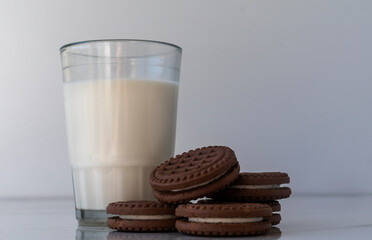 Chocolate chip cookies with milk on a light background. Chocolate sandwich - cookies.
