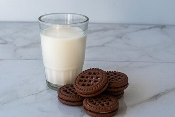 Chocolate chip cookies with milk on a light background. Chocolate sandwich - cookies.
