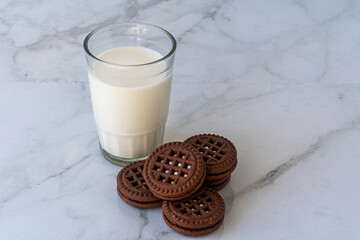Chocolate chip cookies with milk on a light background. Chocolate sandwich - cookies.