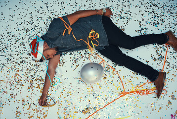 I think I overdid it. High angle shot of a drunk young man passed out of the dance floor during a...