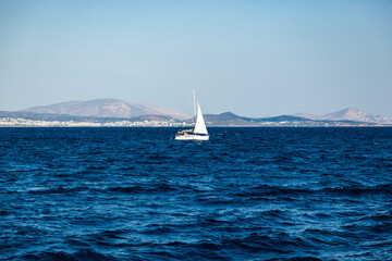 Fototapeta na wymiar Sailing yachts in the sea bay against the backdrop of mountains off the coast of Greece.