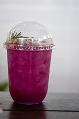 A cup of iced grape flavored soda. Summer cocktail
