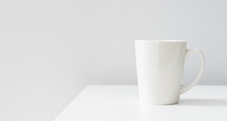 One white ceramic cups on the table