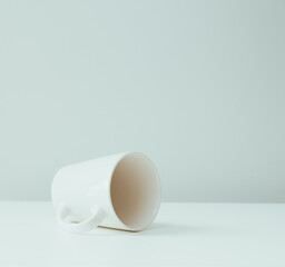 A poured white ceramic mug on the table