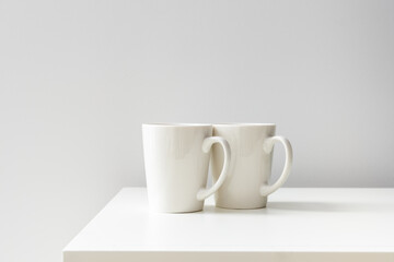 Two white ceramic cups on the table