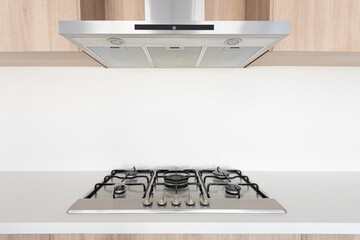 Range hood and gas stove in modern home kitchen