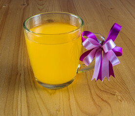 a glass orange juice closeup on a light wooden table background © Yaroslav