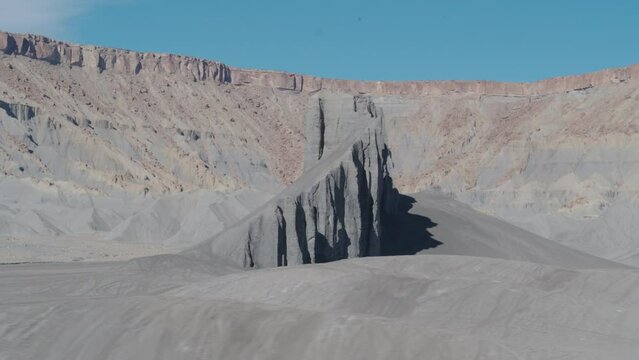 Low drone rotating around Knife's Edge rock formation in Swing Arm City, Utah