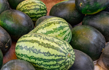 Selective focused watermelons inside of a fruit shop close up