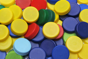 Sorting recycling plastic caps in different colors, top view ...