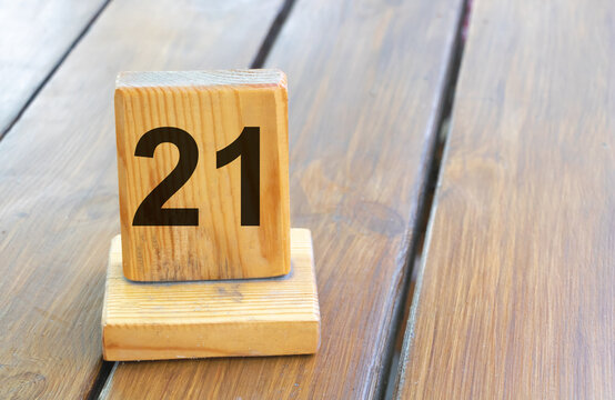 Wooden priority number 21 on a plank tab
