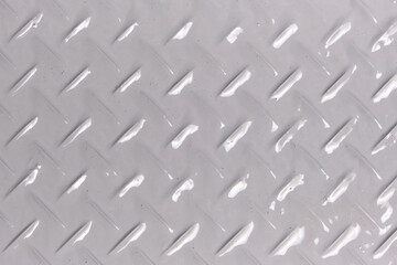 Background, texture of metal with diamond shaped pattern, painted with gray paint.