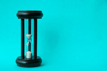 Minute glass isolated on light blue background. Copy space concept