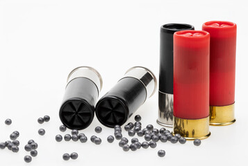 Shotgun shell ammunition and lead pellets on white background , gun and shooting game