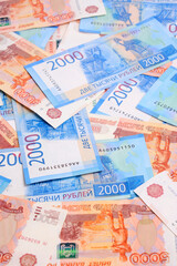 Background, Russian rubles banknotes in denominations of two and five thousand rubles.
