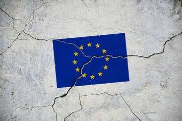An old image of the flag of European Union on a wall with a crack. A crisis.