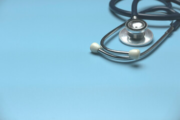 a stethoscope on a blue background with copy space.