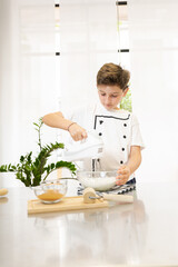 A child with cochlear implant, hearing impairment learning to cook