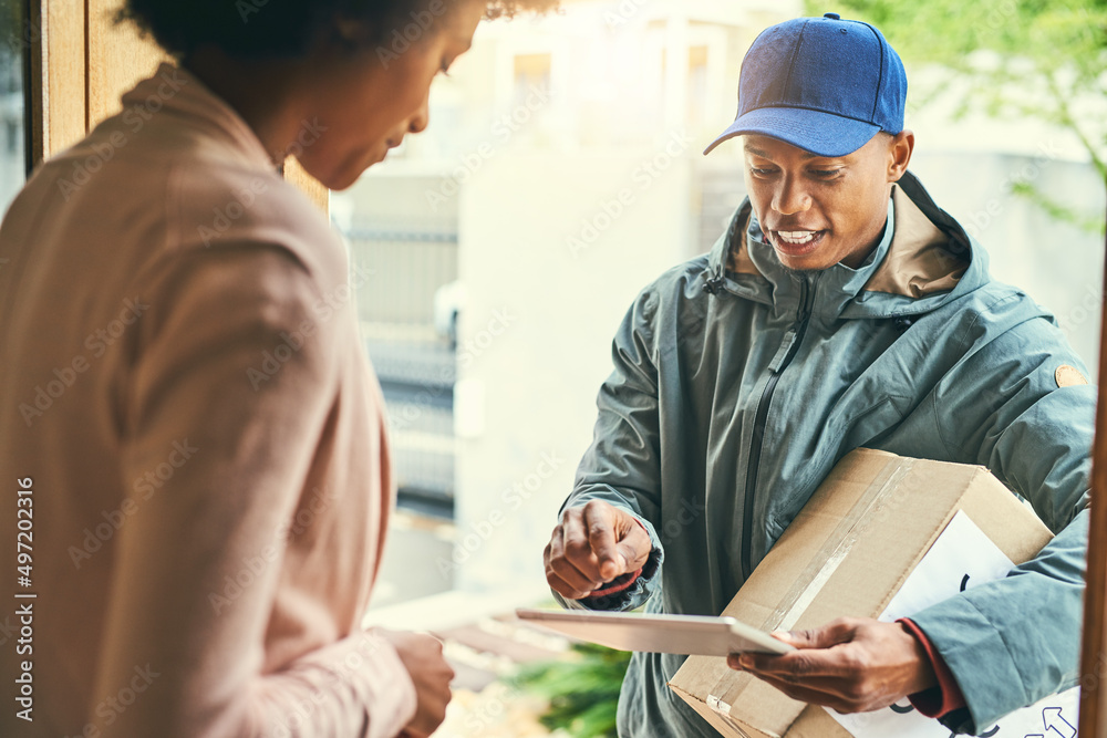 Aufkleber Technology helps us get the job done quicker. Shot of a courier using a digital tablet while making a delivery to a customer.