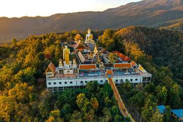 Aerial view of Wat Phrathat Doi Kham, Buddha pagoda and golden chedi in Chiang Mai, Thailand