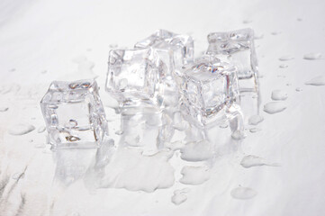 Clear ice cubes for cooling drinks on a light background.