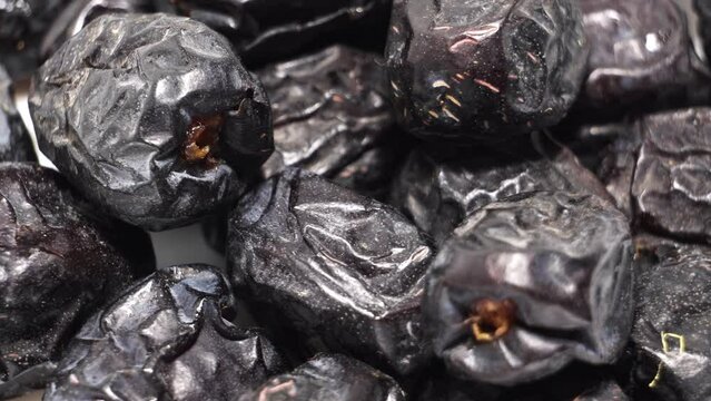 Ajwa dates fruit closeup background. Selective focus 